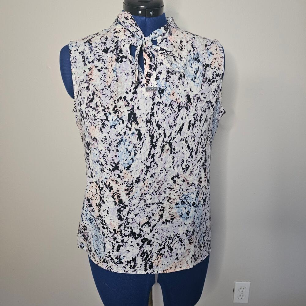 Calvin Klein sleeveless blouse with a tie neck and multi-color abstract print